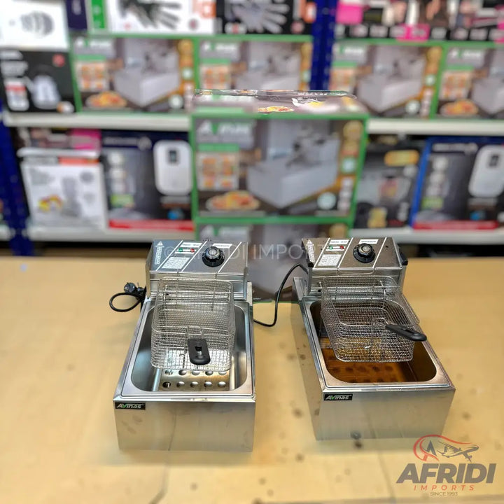 Two stainless steel deep fryers with baskets.
