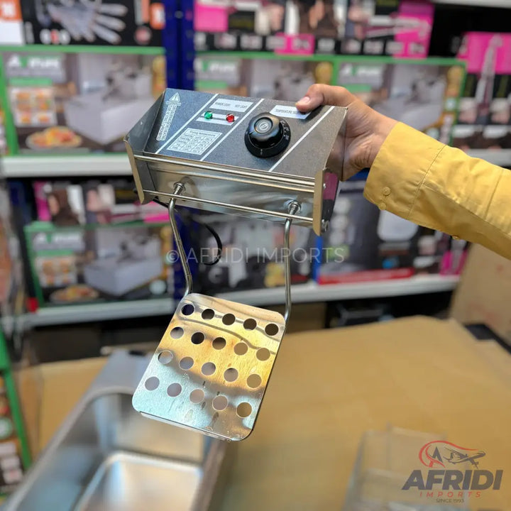 A stainless steel electric deep fryer heating element with a control panel and a perforated basket.