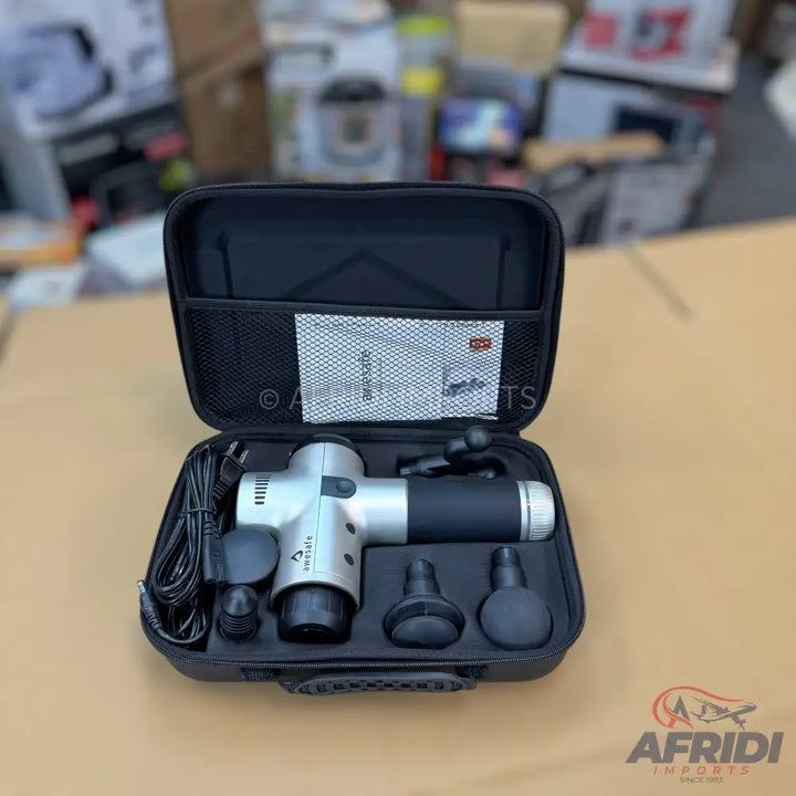 Silver and black percussive massage gun with multiple interchangeable heads and a charger in a carrying case.
