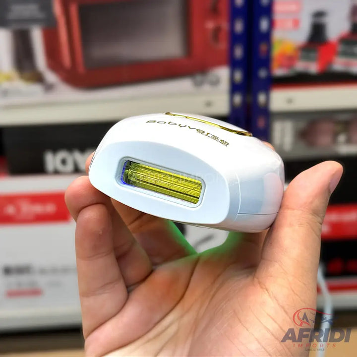White handheld laser hair removal device with a yellow-tinted treatment window.