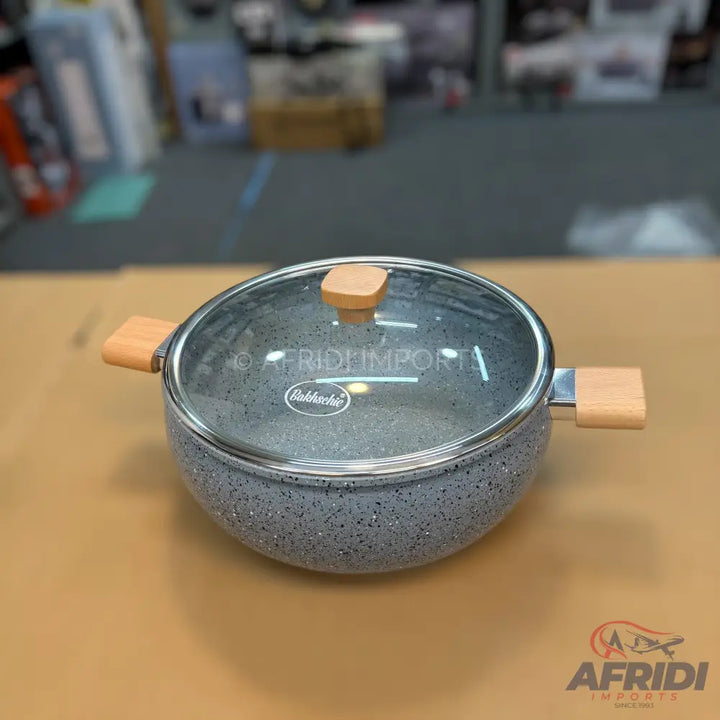 Gray speckled non-stick cooking pot with wooden handles and a glass lid.