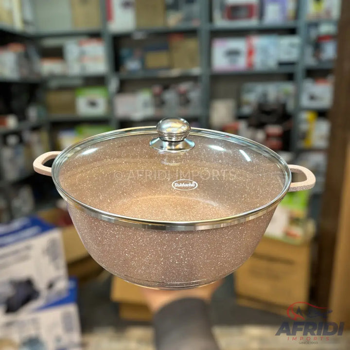 Rose gold speckled nonstick pot with a glass lid and light-colored handles.