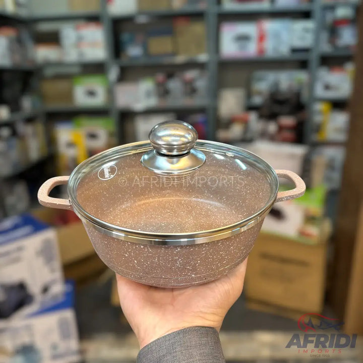 Speckled non-stick cooking pot with a glass lid and two handles.