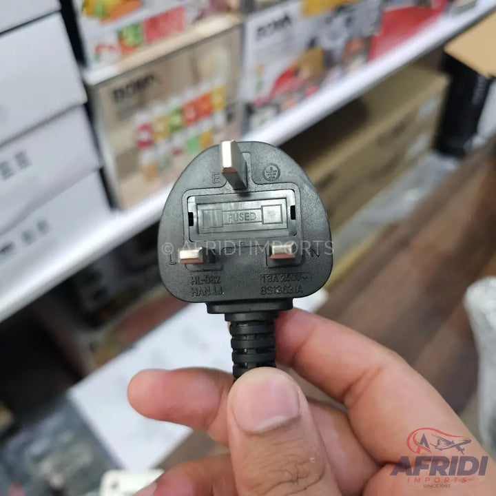 Black 3-pin UK-style electrical plug with a visible fuse.
