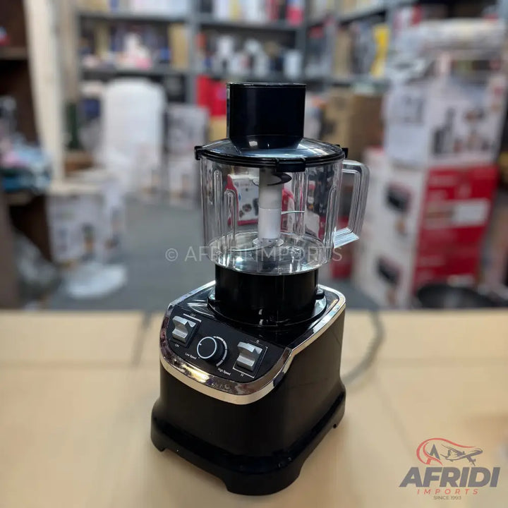 Black and silver food processor with a clear blending pitcher.