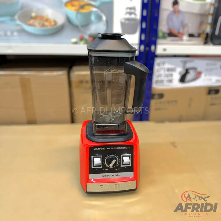 Red blender with black controls and a clear pitcher.