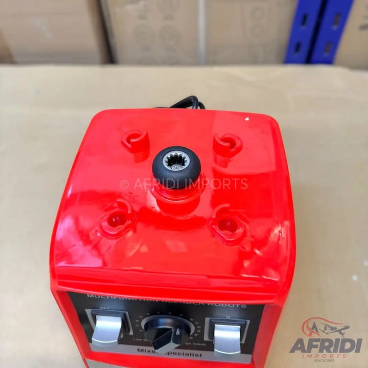 Red blender base with a central drive shaft and front control panel.