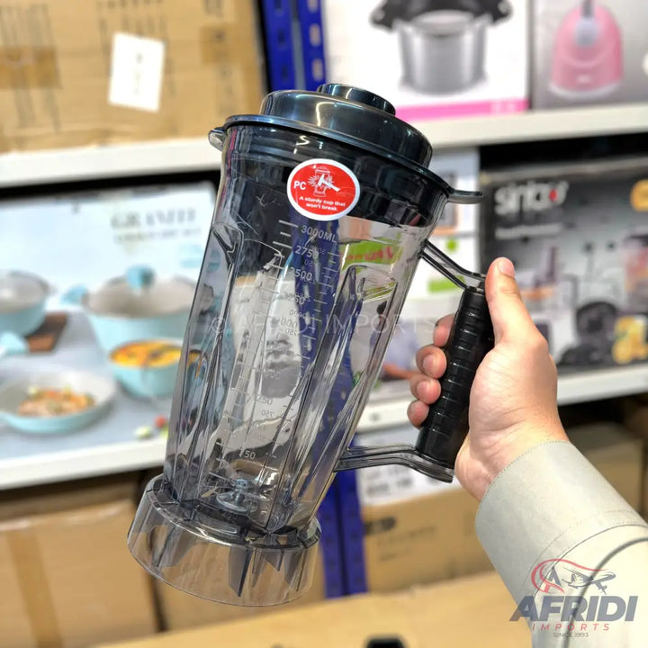 Clear plastic blender jar with a black handle and lid.