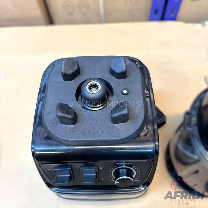 A black professional-grade blender base with a variable speed dial and two control switches.