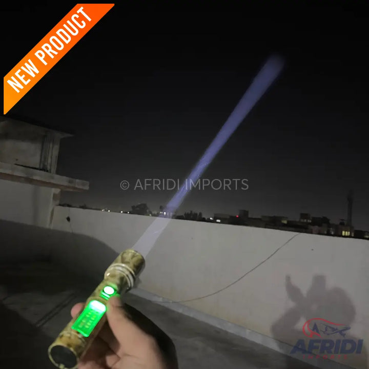 A gold and black flashlight with a glowing green display, emitting a bright blue beam of light.