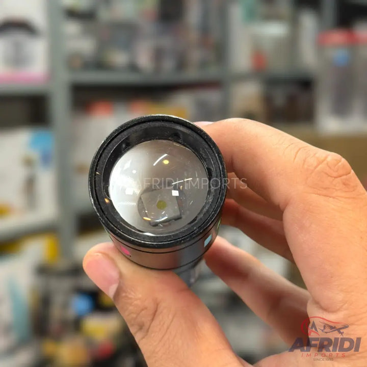 A black flashlight with a clear lens revealing a square LED emitter.