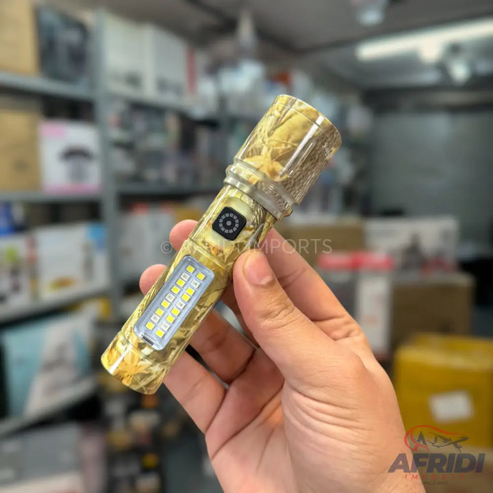 Handheld camouflage-patterned flashlight with a side panel of LED lights and a central button.