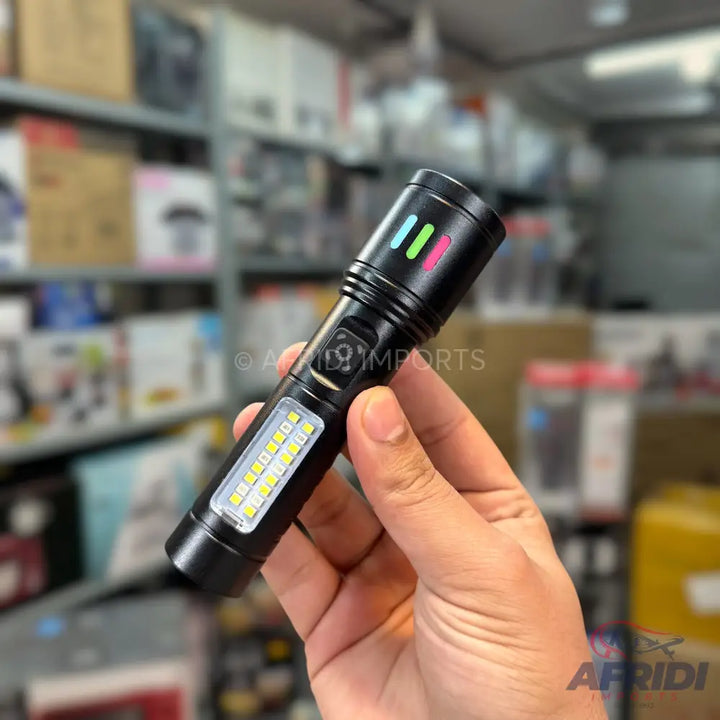 A black, multi-functional flashlight with a side panel of small LED lights and three colored indicator bars.
