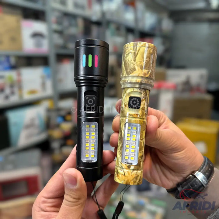 Two handheld flashlights, one black and one camouflage, both featuring side-mounted LED panels and top-mounted colored indicator lights.