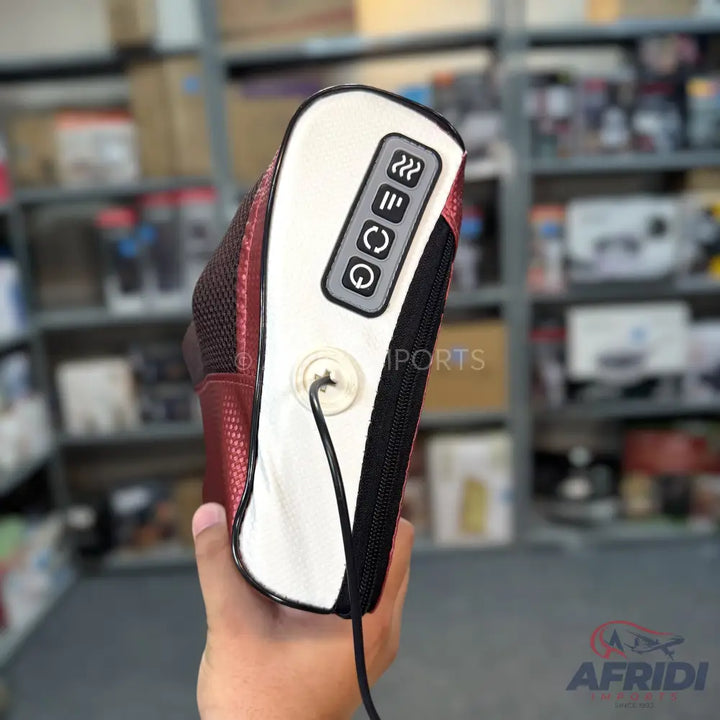 A portable red and white electric massager with control buttons.