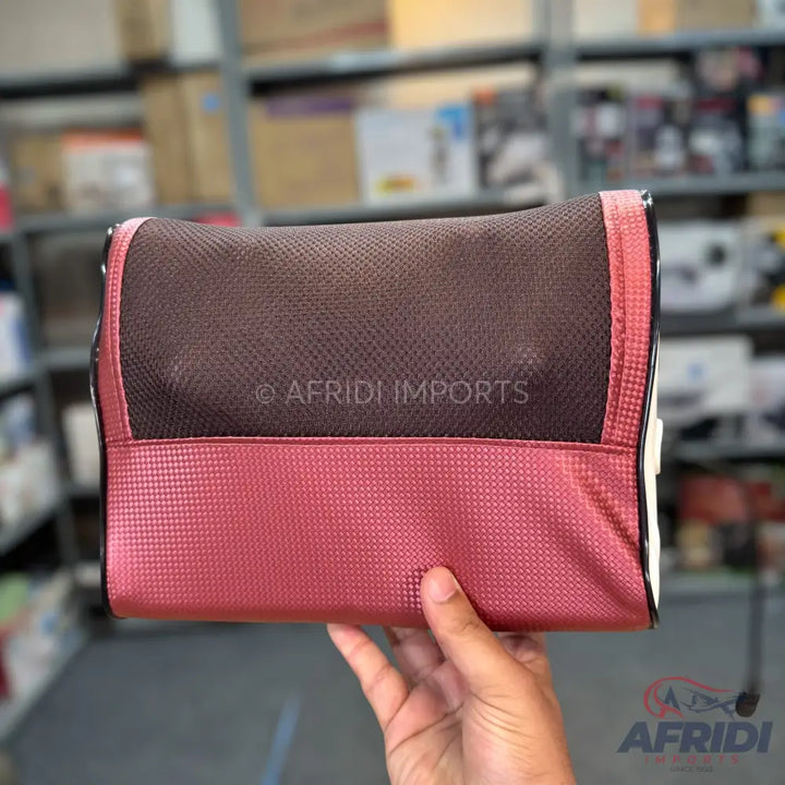 A two-tone brown and reddish-pink massaging pillow with a textured surface.