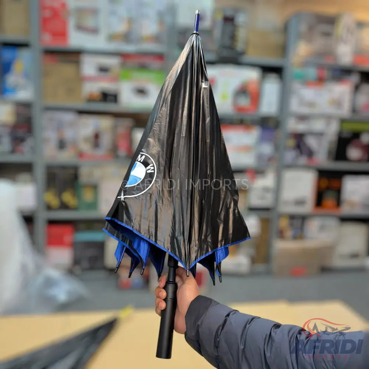 Black BMW umbrella with a blue interior.