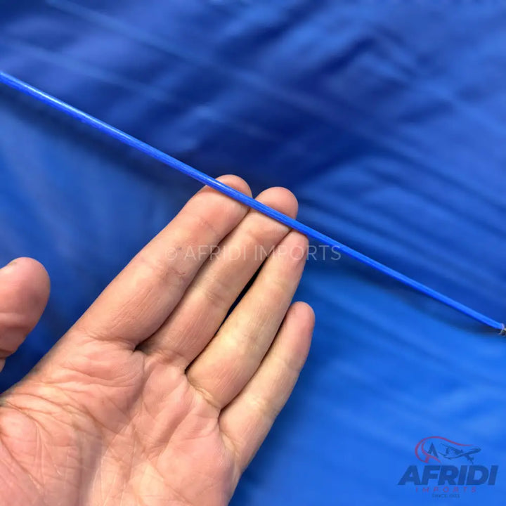 A hand holding a thin blue wire.