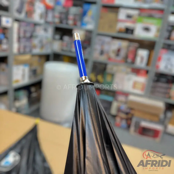 Black umbrella with a blue handle.