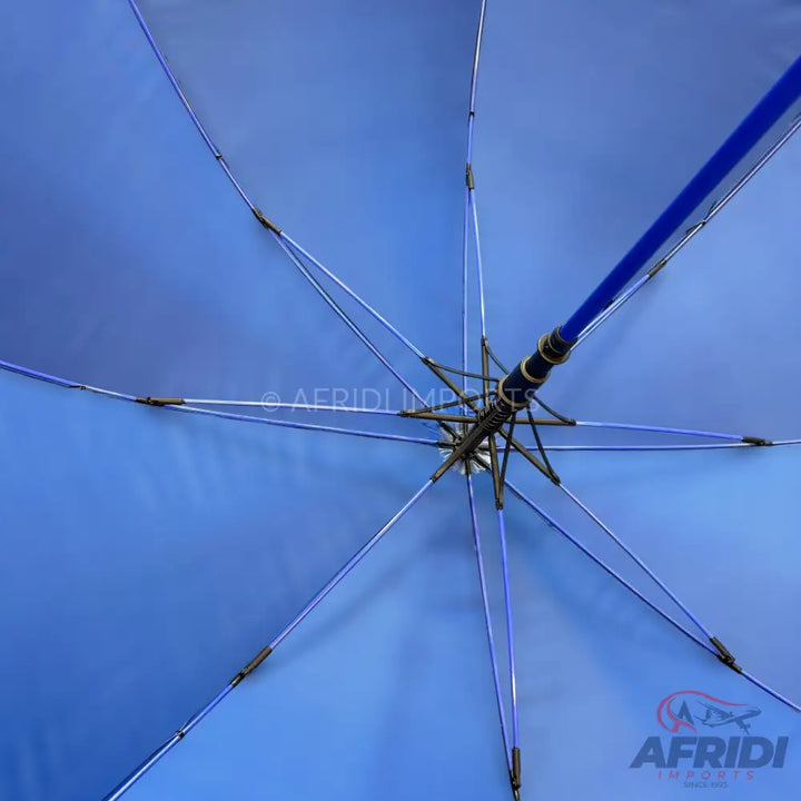 Underside of a blue umbrella with a sturdy frame.