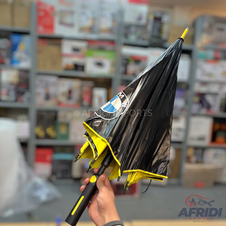 Black and yellow umbrella with a BMW logo