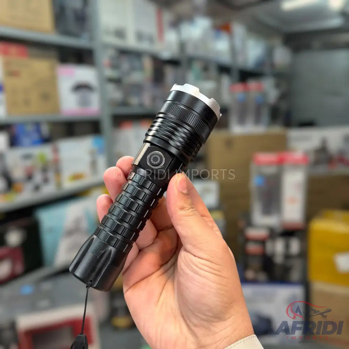 Black tactical flashlight with a textured grip and a side power button.