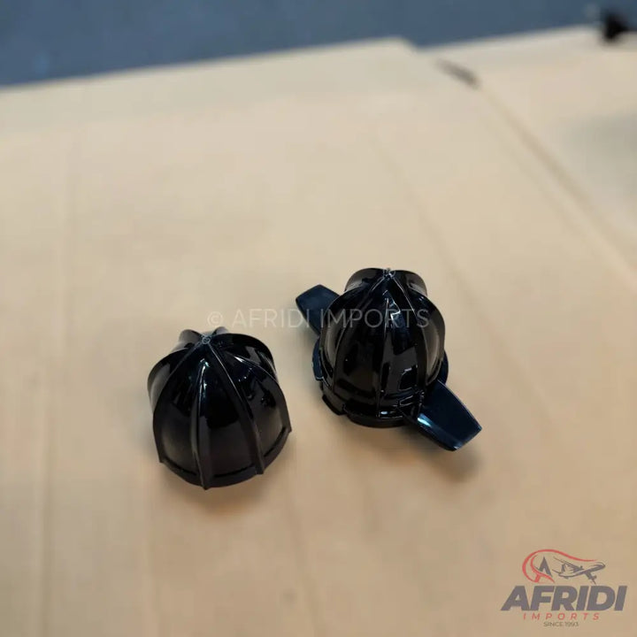 Two shiny black plastic juicer cones.