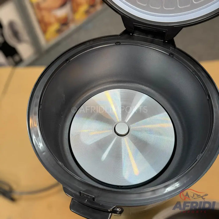 An open black and silver rice cooker with a brushed metal heating plate.
