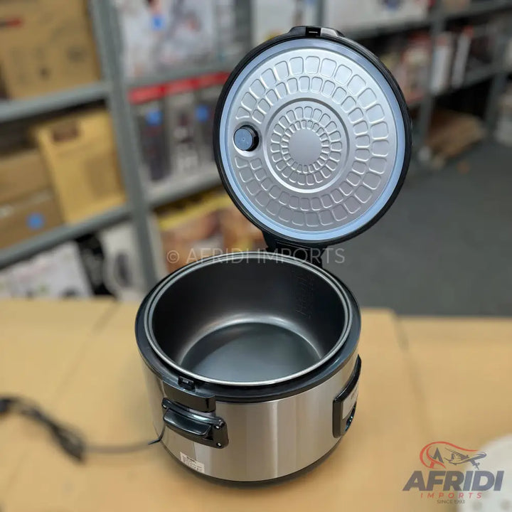 Stainless steel rice cooker with an open lid revealing a non-stick inner pot.