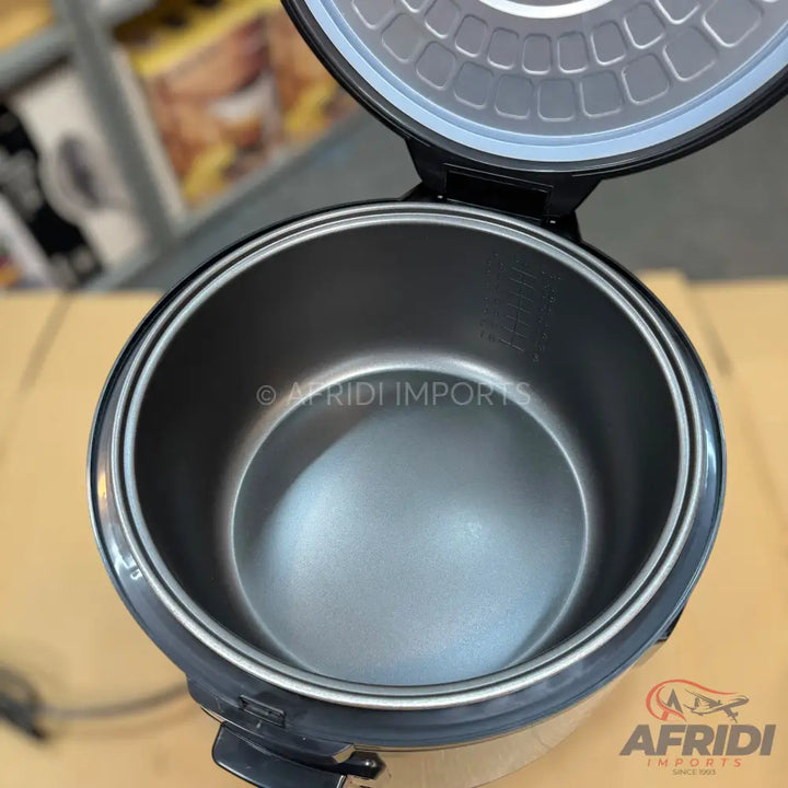 An open rice cooker with a stainless steel inner pot.