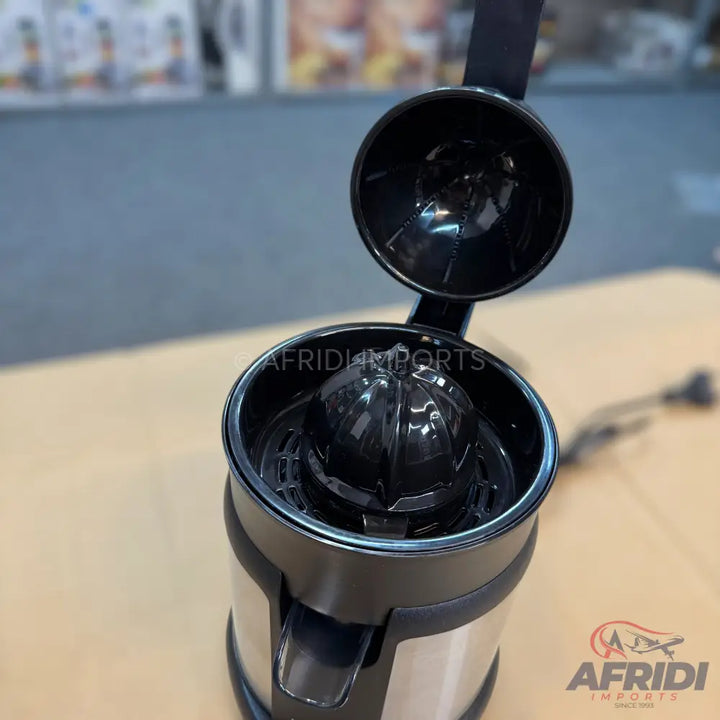 Black and silver citrus juicer with an open lid.