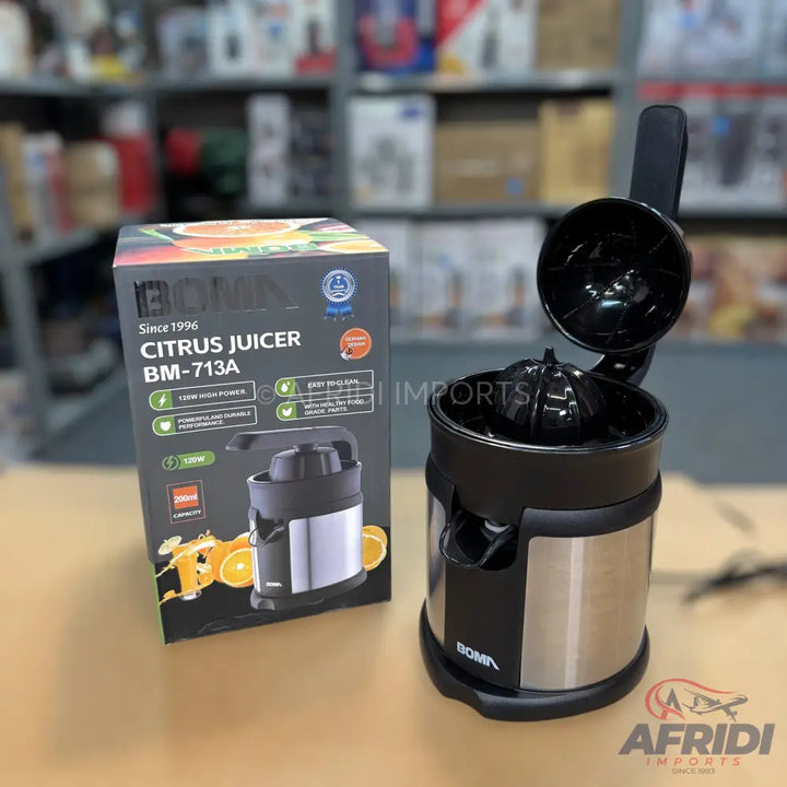 A black and silver electric citrus juicer with an open lid, accompanied by its packaging.