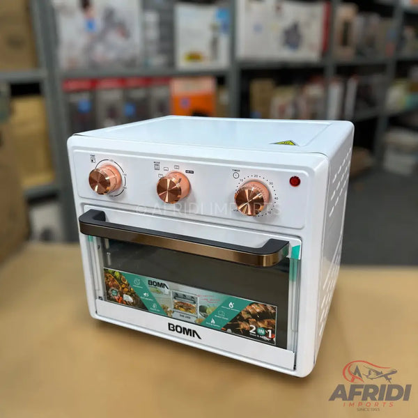 White electric oven with rose gold controls and handle.