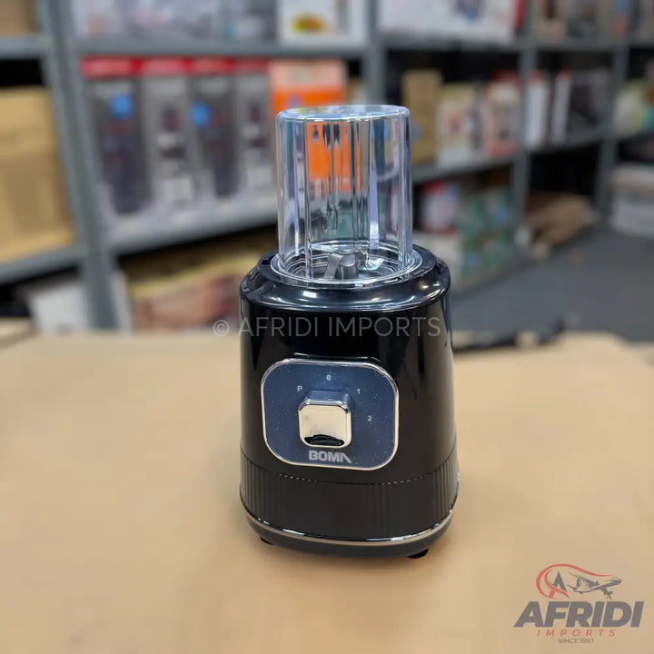 Black personal blender with a clear blending cup and a control dial.