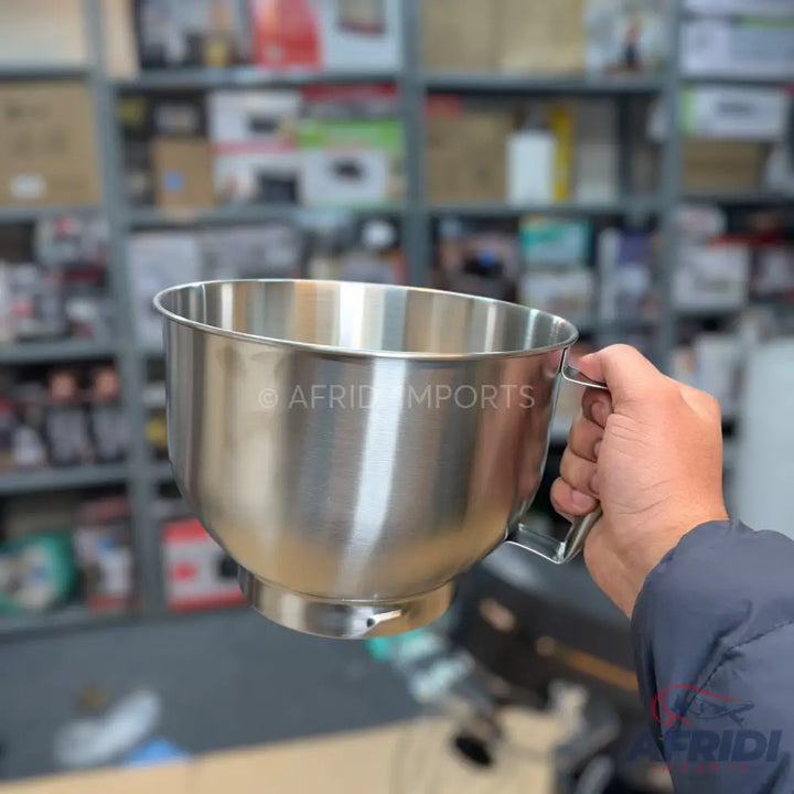 Stainless steel mixing bowl with a handle.