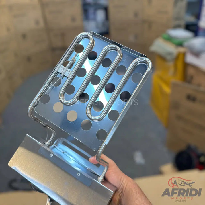 A stainless steel deep fryer heating element with a perforated basket.