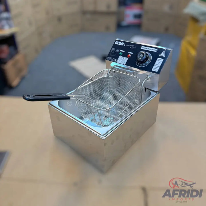 A stainless steel electric deep fryer with a mesh basket, temperature control dial, and indicator lights.