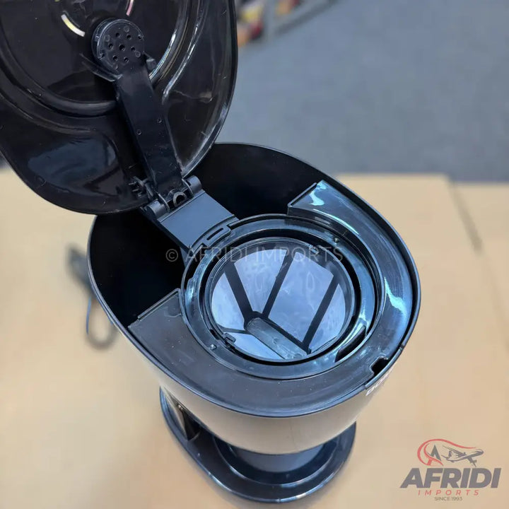 Open black coffee maker with a reusable mesh filter basket.