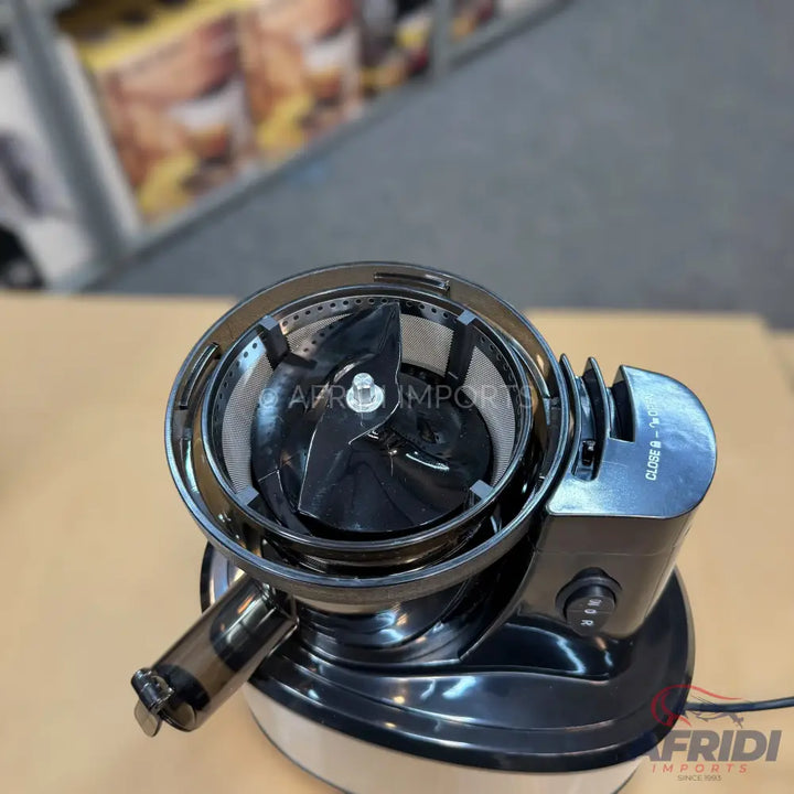 Black electric centrifugal juicer with a wide feed chute and mesh filter.