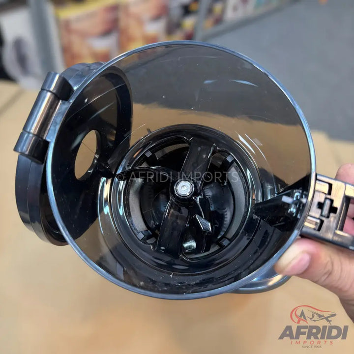 A black plastic coffee grinder with a transparent lid and visible grinding blades.