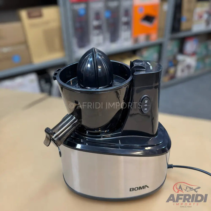 Black and silver electric citrus juicer with a spout and a textured reamer.