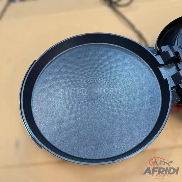 Round, black non-stick baking pan with a textured bottom.