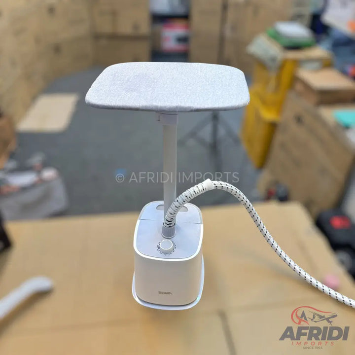 White standing garment steamer with an ironing board.