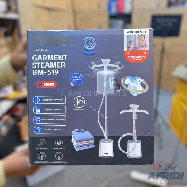 Box for a ’Goma Garment Steamer BM-519’’ with 1800W power, featuring a 1-year warranty, professional ironing capabilities, German design, freedom of movement, safety cap design, beauty to remove wrinkles, and options for steaming various clothes.