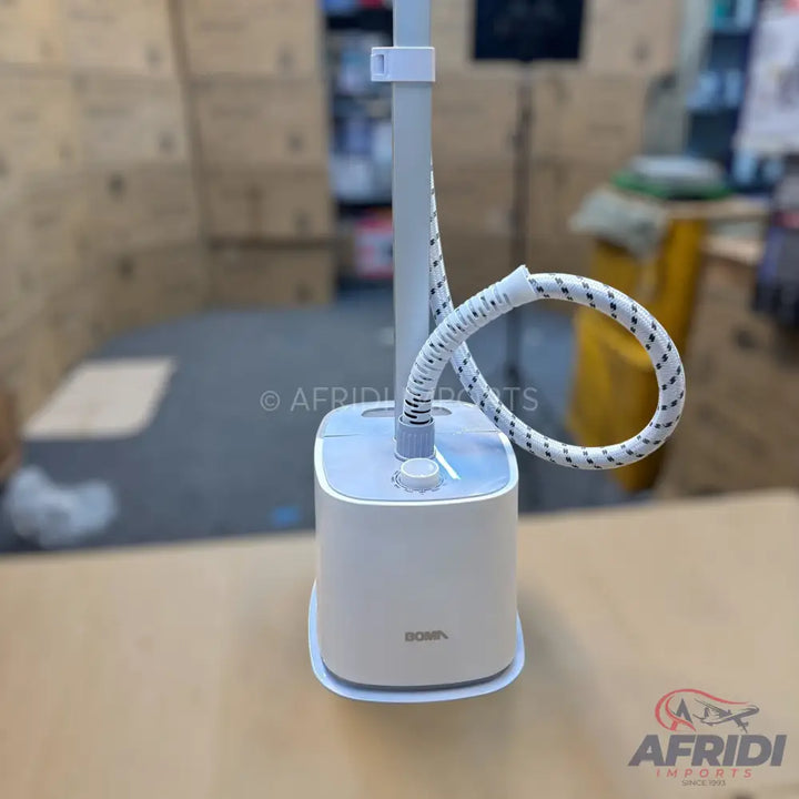 A white standing garment steamer with a flexible hose and a control knob.