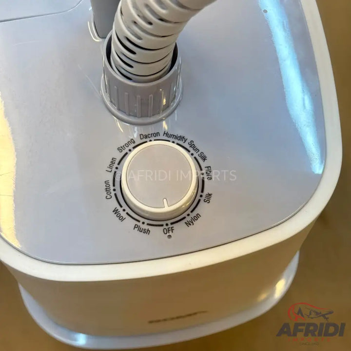 White garment steamer with a fabric selector dial.