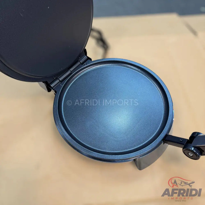 Open black electric flatbread maker with a non-stick cooking surface.