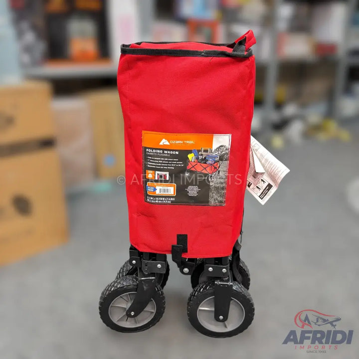 A red folding wagon with all-terrain wheels.