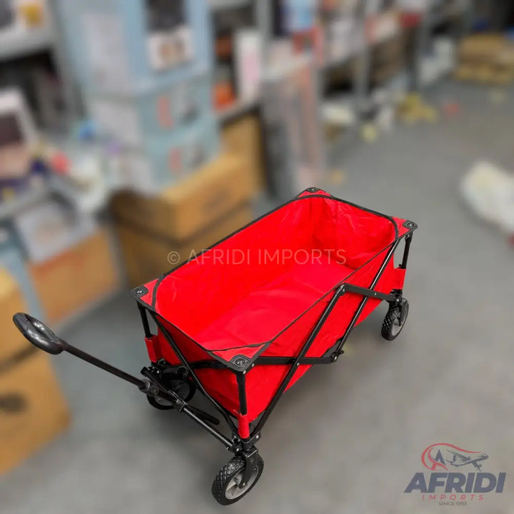 Red foldable utility wagon with a black frame and wheels.