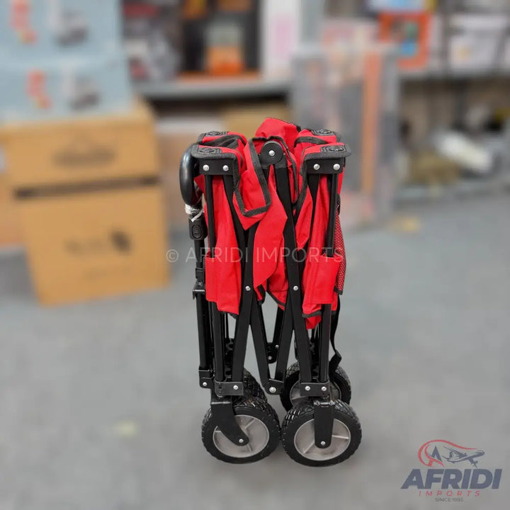 Foldable red utility wagon with black frame and wheels.